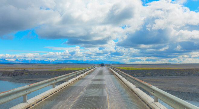 Empty bridge over the river with amazing cloudy sky - Iceland