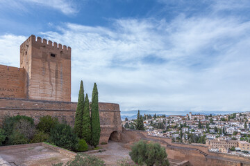 Amazing panorama of Granada city and Alhambra's Alcazaba fortress. Scenic view from Generalife gardens on a sunny day with blue sky above. Granada, Andalusia, Spain.                                   