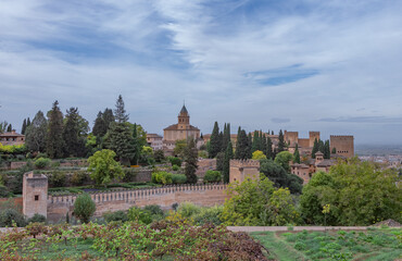 Fototapeta na wymiar Amazing panorama of Granada city and Alhambra's Alcazaba fortress. Scenic view from Generalife gardens on a sunny day with blue sky above. Granada, Andalusia, Spain. 