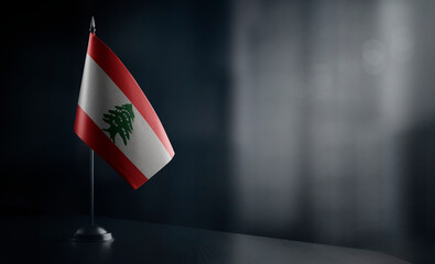 Small national flag of the Lebanon on a black background - obrazy, fototapety, plakaty