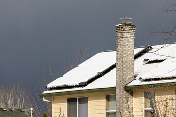 Solar panel covered in snow on a roof of a house in a Hillsboro nighborhood, Oregon