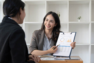 Obraz premium Two business leaders talk about charts, financial graphs showing results are analyzing and calculating planning strategies, business success building processes