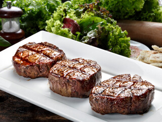 Three steaks roasted on the grill