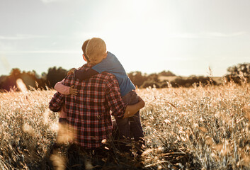 Child giving his father a hug. Family parenting concept. 