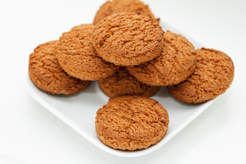 Sweet crisp, freshly baked oatmeal, folded in a triangle shape on a plate, top view, background