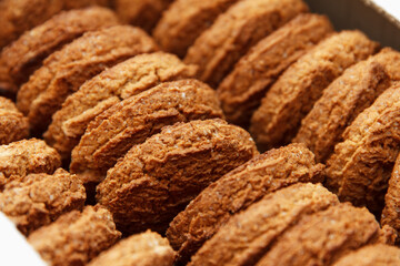 Sweet crisp freshly baked oatmeal, stacked one by one and conveniently packaged into a paper box