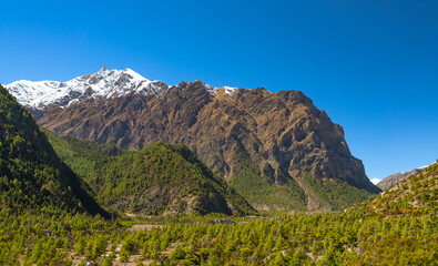 Picturesque landscape with himalayan mountains in the distance on the Annapurna circuit trek, Nepal