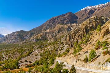 Picturesque landscape of the Annapurna Circuit trek  with footpath on a sunny fall day