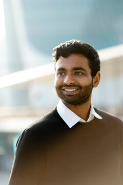 Portrait Smiling Handsome Indian Man Looking Away On The Street