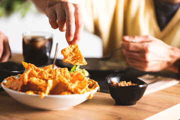 man taking a nacho nacho totopo mexican tortilla