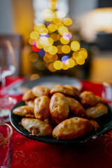 Christmas pastry with bacon on a Christmas table and lights in background
