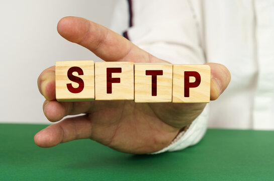 In the man's hand are cubes with the inscription - SFTP