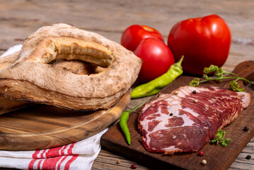 Homemade lepinja bread and appetizer on wooden background