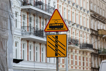 Yellow warning road sign A7: tram. The sign warns about crossing the tram tracks