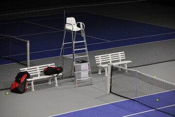 Close up view of empty tennis court with sports referee seat after competition