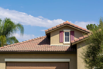 Tiled roof and attic window of a single-family residence, Menifee, California, USA