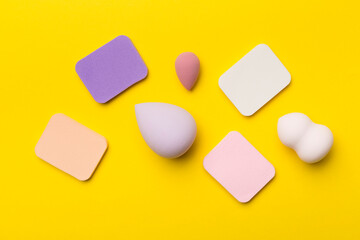 Beauty blenders on color background, top view