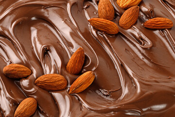 Chocolate cream with almond nuts. Sauce, paste, syrup. Background of  Liquid chocolate. Curl. Texture, Close up, top view.