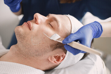 Fototapeta premium Close-up on a man in cosmetologist cabinet has a skincare procedure