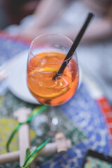 Vertical photo of aperol spritz cocktail in summer with blue background