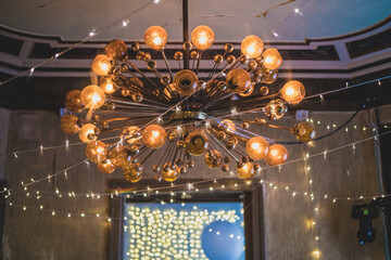 Vintage style chandelier with big light bulbs in old school design festive event