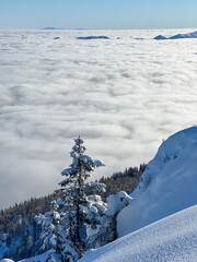 Fototapeta na wymiar Winter mountains covered with snow landscape over clouds
