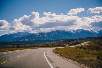 Naklejka premium Road trip imagery - driving on an open road through the Colorado Rocky Mountains in the fall