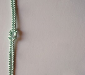 Knotted Satin Rope as Right Vertical Border on White Background