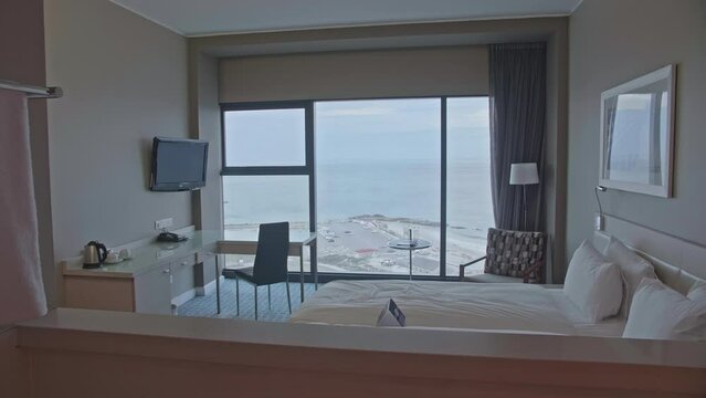 Cosy hotel room with white bed seaside view South Africa