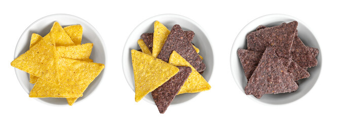 Yellow, mixed and blue tortilla chips, in white bowls. Snack food, made from corn tortillas, cut into triangle shaped wedges, fried in oil and slightly salted. Close-up, from above, isolated, photo.