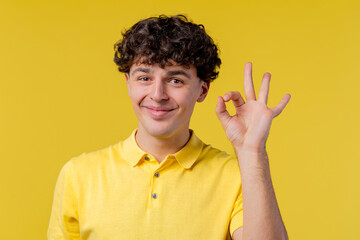 Handsome man makes hand sign okay, ok gesture. Happy guy, correct perfect choice, great deal,...