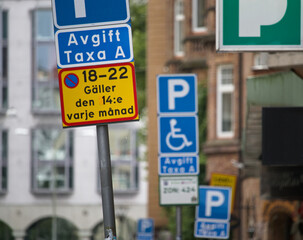 Multiple parking road signs with additional information in Sweden, located on the side of the road.