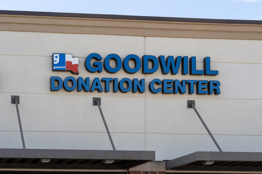 Houston, TX, USA - March 9, 2022:  Close up of Goodwill Donation Centre sign on the building is shown.  Goodwill is a long-standing nonprofit chain with a range of pre-owned clothing and housewares.