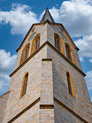 Fototapeta premium Tower of the collegiate church in Bielefeld taken from below on a beautiful day