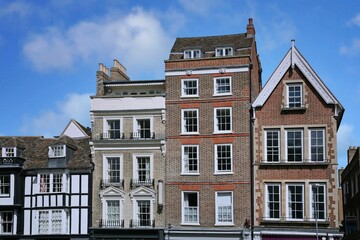 Fototapeta na wymiar Row of tall, narrow old buildings with apartments on top and stores below, Cambridge, England
