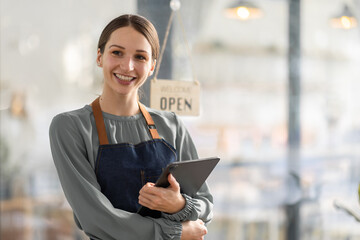 Young american businesswoman small business owner standing at cafeteria door entrance pen...