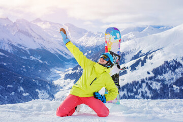 Girl snowboarder enjoys the winter ski resort. - 557072393