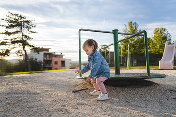 One girl small caucasian child female toddler 18 months old in park play in day by speedy spinner...