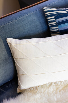 Vintage denim and white fabric pillows on a couch