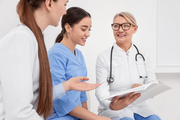 Team of professional doctors having discussion in clinic