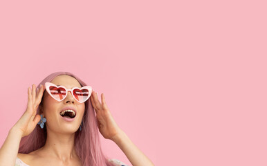 Girl wearing pink heart-shaped glasses with pink hair