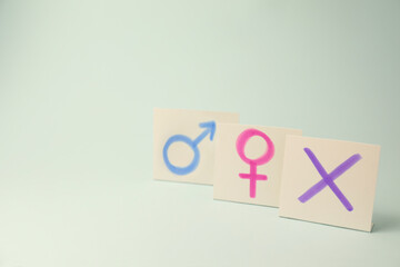 Gender identity concept. Cards with cross mark and gender symbols on light background, space for text