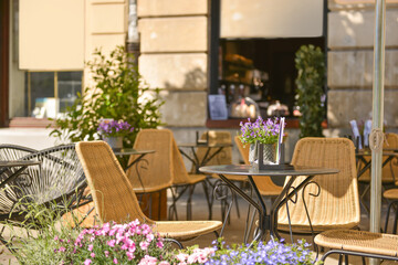 Fototapeta na wymiar Outdoor cafe with beautiful flowers and comfortable furniture