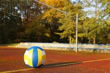 View of colorful ball on volleyball court outdoors