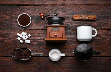 Flat lay composition with vintage manual grinder and geyser coffee maker on wooden background - Powered by Adobe