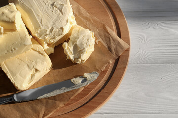 Tray with tasty homemade butter and knife on white wooden table, top view