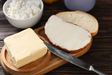 Tasty homemade butter, bread slices and tea on wooden table, closeup