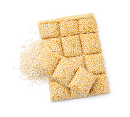 Tasty sweet kozinaki bars and sesame seeds on white background, top view