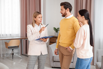 Real estate agent working with couple in new apartment