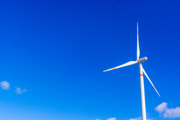 Fototapeta premium windmill in a sunshine day. Concept of alternative energy wind turbines horizontal at the south coast